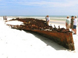 People look over the wreck of a wooden ship uncovered by Hurricane Ike on a beach on Fort Morgan Road in Fort Morgan, Ala., Tuesday, Sept. 16, 2008.
(AP)